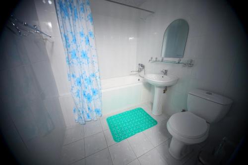 a bathroom with a toilet and a sink and a mirror at Samarkand Dream Hotel in Samarkand