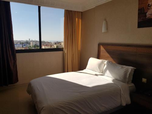 Ein Bett oder Betten in einem Zimmer der Unterkunft Hotel al Madina