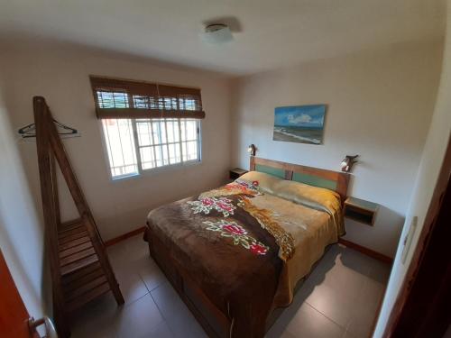 a bedroom with a bed and a ladder in it at La Nubia Cabañas in Conlara
