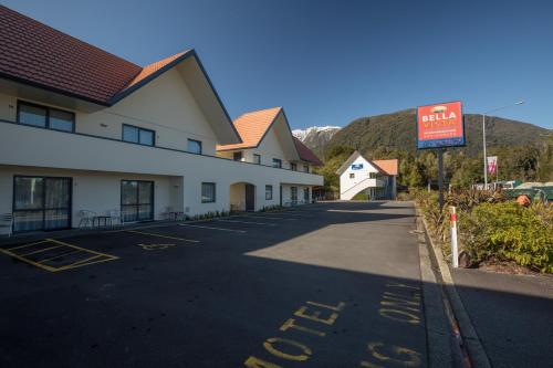 an empty parking lot in front of a building at Bella Vista Motel Fox Glacier in Fox Glacier