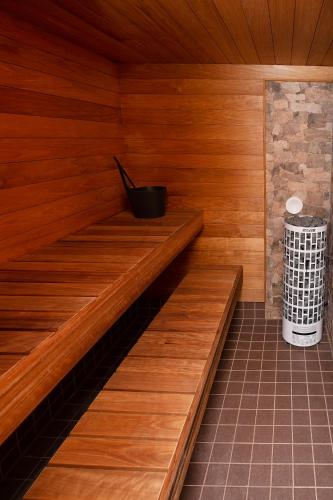 a sauna with a trash can in the middle at Lossi 32 Luxury Apartment with Sauna in Tartu