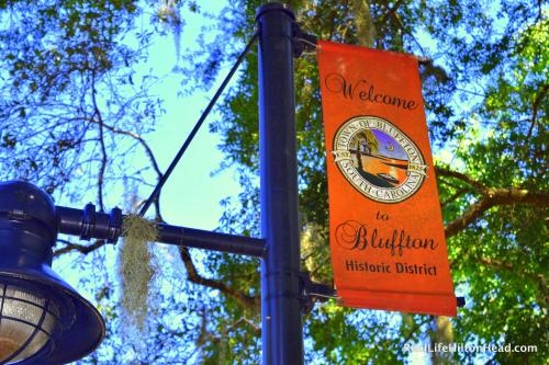an orange sign on a pole with a street light at Candlewood Suites - Bluffton-Hilton Head by IHG in Bluffton