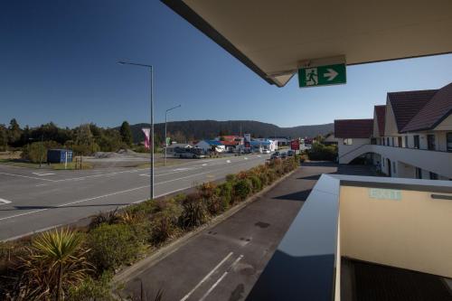 a street sign at a gas station with a road at Bella Vista Motel Fox Glacier in Fox Glacier