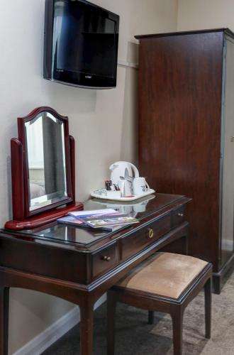 a dresser with a mirror on top of it at Best Western Claydon Hotel in Ipswich