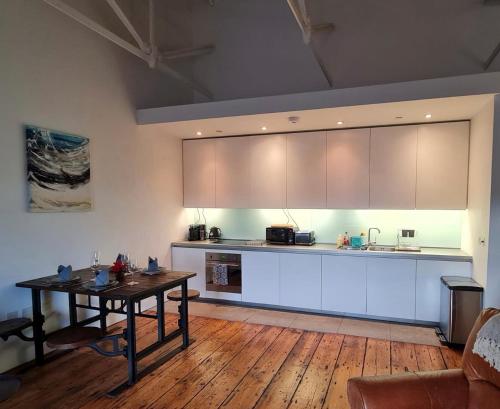 a kitchen with a table and a counter top at Clarence at Royal William Yard in Plymouth