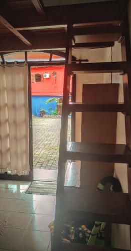 a view of a bedroom with a bed and a window at Pousada Em Busca do Sol in Trindade