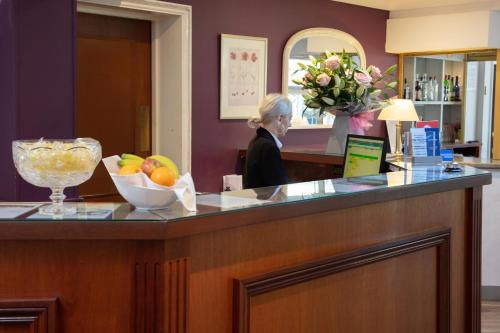 a woman sitting at a counter in a salon at Best Western Claydon Hotel in Ipswich