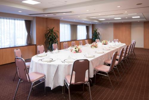 a large conference room with a long table and chairs at International Garden Hotel Narita in Narita