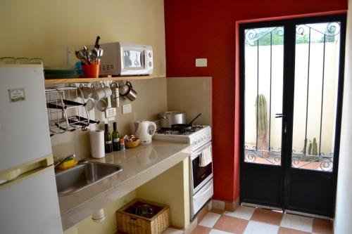 a kitchen with a sink and a stove top oven at Kamay Apart Cafayate in Cafayate