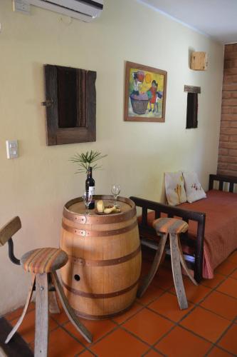 a room with a bed and a wine barrel at Kamay Apart Cafayate in Cafayate