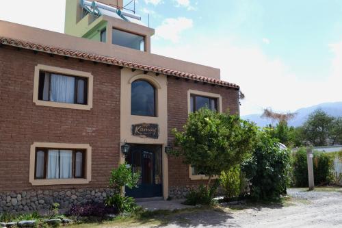 a brick building with a sign on it at Kamay Apart Cafayate in Cafayate
