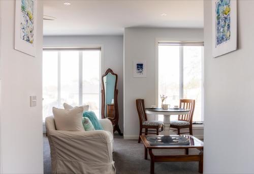 a living room with a couch and a table at Bellarine getaway close to beach in Curlewis