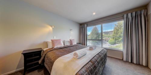 سرير أو أسرّة في غرفة في Distinction Wanaka Alpine Resort
