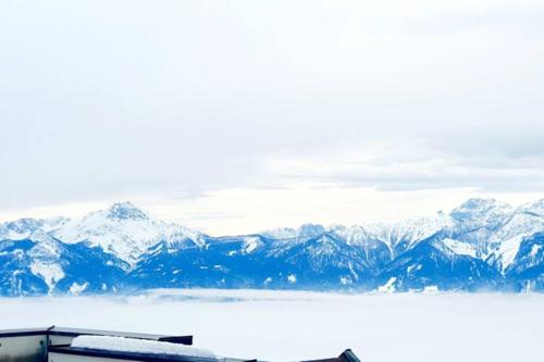 a view of a snow covered mountain range from an airplane at Kozma Apartment Gerlitzen in Kanzelhöhe