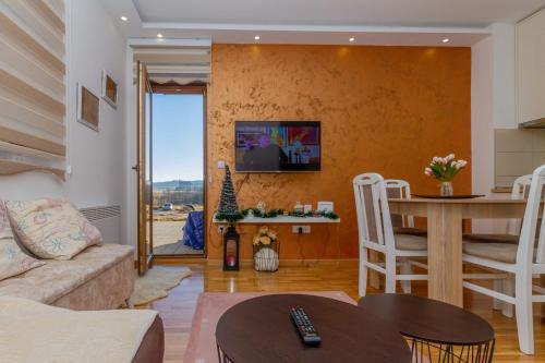 a living room with a couch and a table at Nirvana 06 in Zlatibor