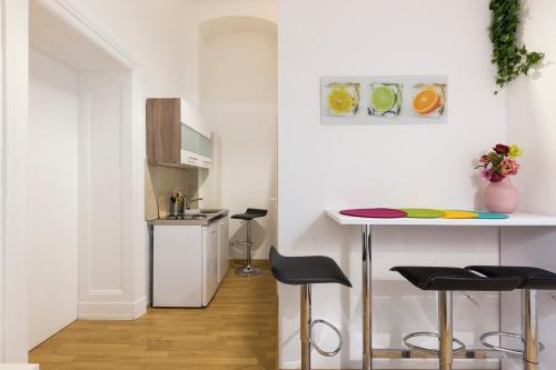a kitchen with a table and stools in a room at Feels like Home in Berlin