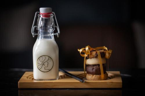 a bottle of milk and a sandwich on a cutting board at Fable Dunedin in Dunedin