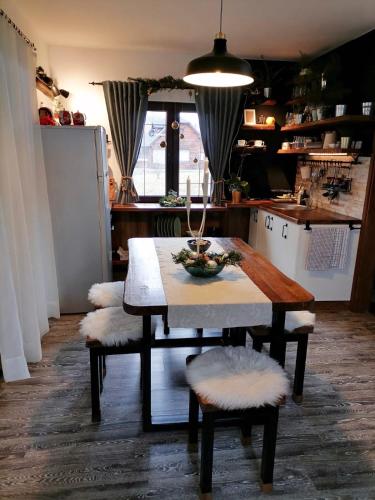 a kitchen with a table and chairs and a kitchen with a kitchen at Holiday Home Drinsko svitanje in Gornja Trešnjica