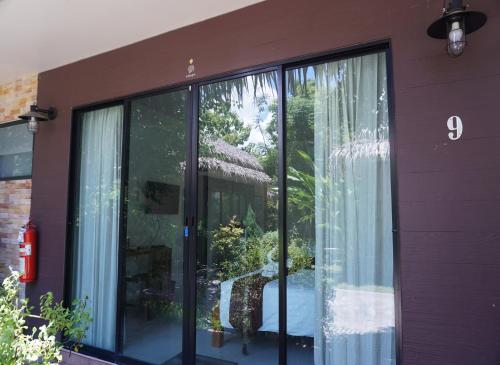 a building with large glass windows on the side of it at Papa's Home And Rabbit Café in Ban Mai
