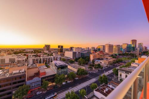 an aerial view of a city at sunset at Toms Court Hotel in Adelaide