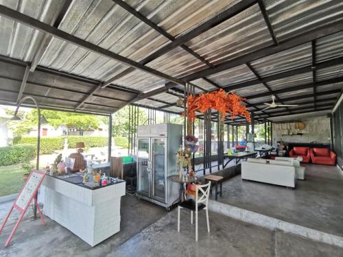a kitchen and living room of a house at De Coco House in Si Racha