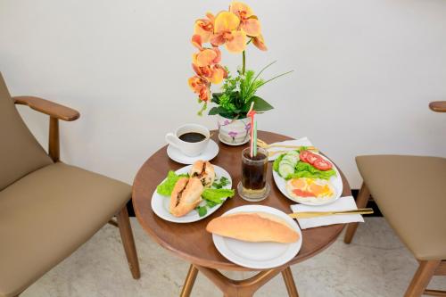 a table with two plates of food on it at Dawn Villa Homestay Hội An in Hoi An