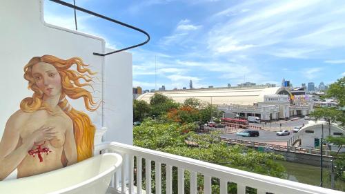 a mural of a woman on the side of a balcony at Kunst in Bangkok