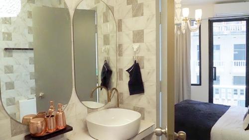 a bathroom with a sink and a mirror at Kunst in Bangkok