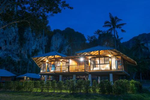 a house in the middle of a forest at night at Tinidee Hideaway Tonsai Beach Krabi - SHA Extra Plus in Tonsai Beach