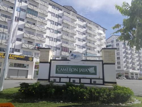 a sign in front of a large apartment building at Fizan Homestay in Tanah Rata