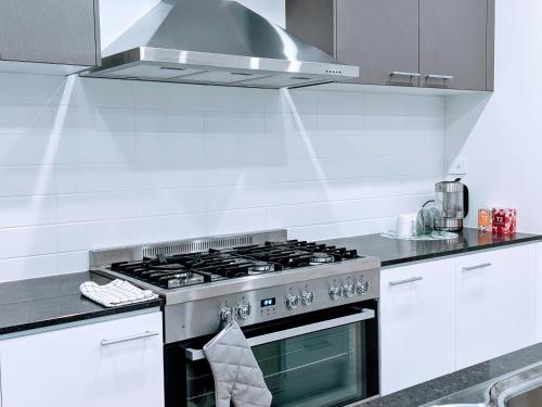 a kitchen with a stainless steel stove top oven at Tarneit Treat in Tarneit