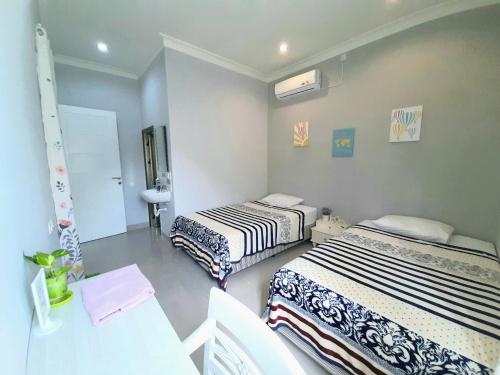 Postel nebo postele na pokoji v ubytování INNI Homestay