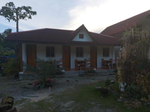 a house with a roof at Gardenview Homestay Siargao in General Luna
