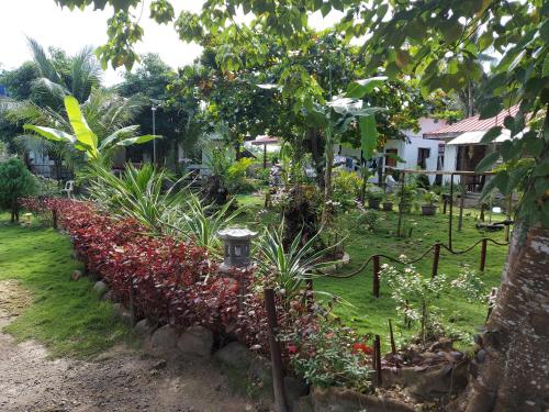 a garden with a row of flowers and plants at Gardenview Homestay Siargao in General Luna