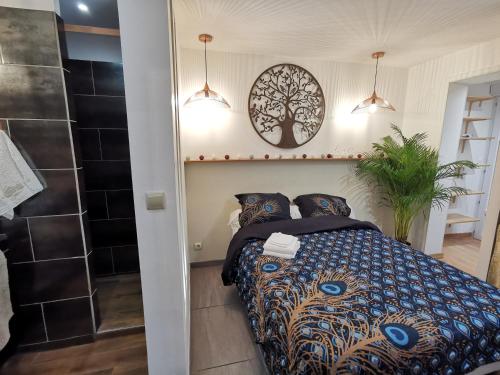 a bedroom with a bed with a tree on the wall at La Terrasse Ensoleillée de Sausset - Côte Bleue in Sausset-les-Pins