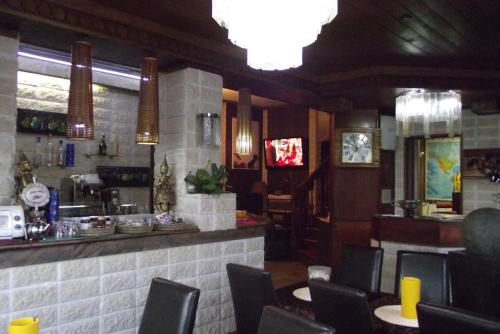 a restaurant with a bar with chairs and a counter at Hotel Total in Pisogne