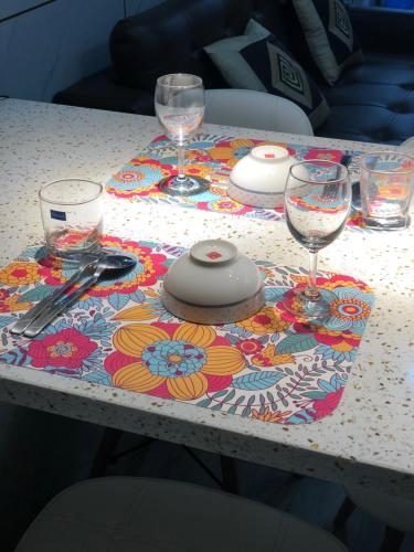 a table with wine glasses and a table cloth on it at SHP Plaza Khanh Phong Homestay in Hai Phong