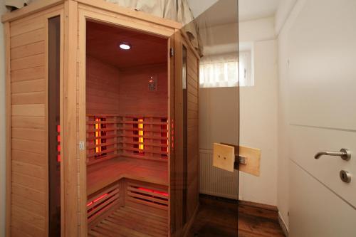a sauna with a wooden door in a room at Chalet Sabrina mit Außenpool im Sommer in Kaprun