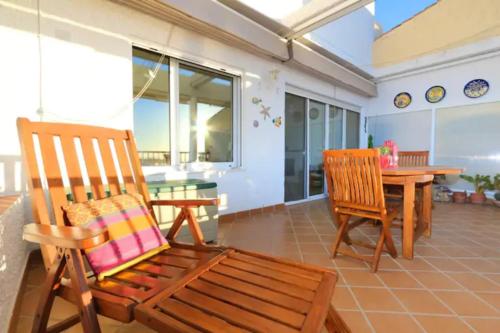 a room with two chairs and a table with a tablektop at Seaview and sun all day long in Los Pinos, Almuñecar, Andalusia in Almuñécar