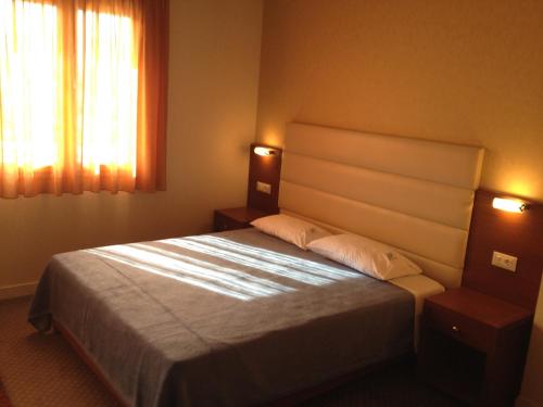 Postel nebo postele na pokoji v ubytování Dionysion