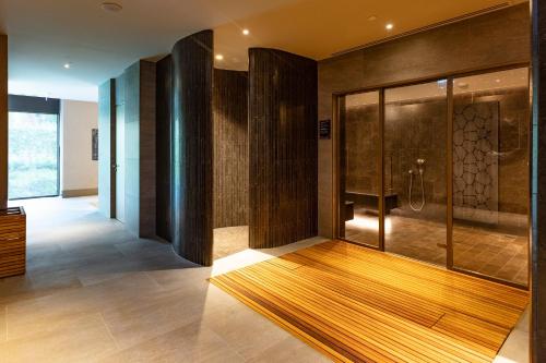 a bathroom with a shower and a wooden floor at NG Enjoy in Sapanca