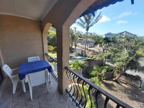 a balcony with a blue table and chairs and a view at Crayfish Inn no5 in Ramsgate