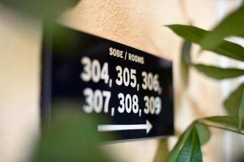 a clock hanging on a wall next to a plant at Hotel Orient Zagreb in Zagreb