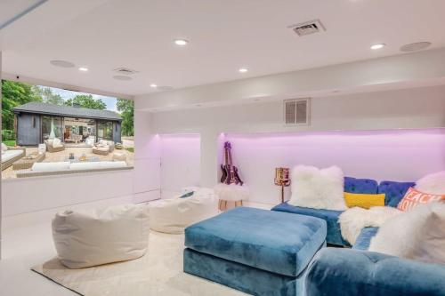 a living room with a blue couch and a table at Villa Ebrar - Luxury with pool in Sag Harbor