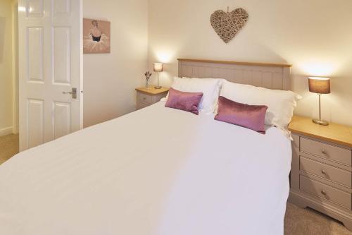 a bedroom with a large white bed with pillows at Host & Stay - Richemont Cottage in Whitby