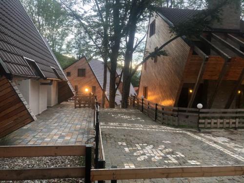 a brick walkway next to a building with a fence at Brezovica Luxury Villa, Brezovicë in Brezovicë