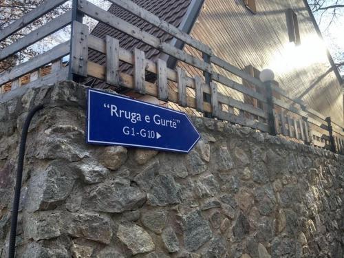 a blue street sign on a stone wall at Brezovica Luxury Villa, Brezovicë in Brezovicë