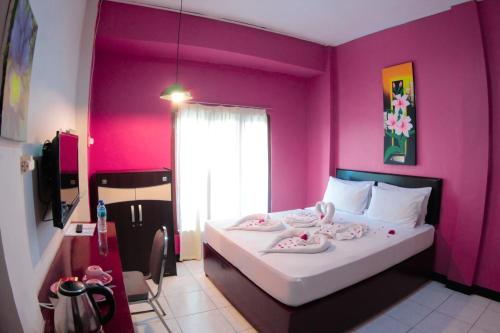 Postel nebo postele na pokoji v ubytování Hotel FX72 Ruteng