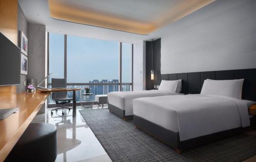 Ένα ή περισσότερα κρεβάτια σε δωμάτιο στο Sofitel Haikou