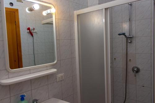 a bathroom with a shower and a sink and a mirror at La Masseria Hotel Ristorante Centro Benessere in Cocumola